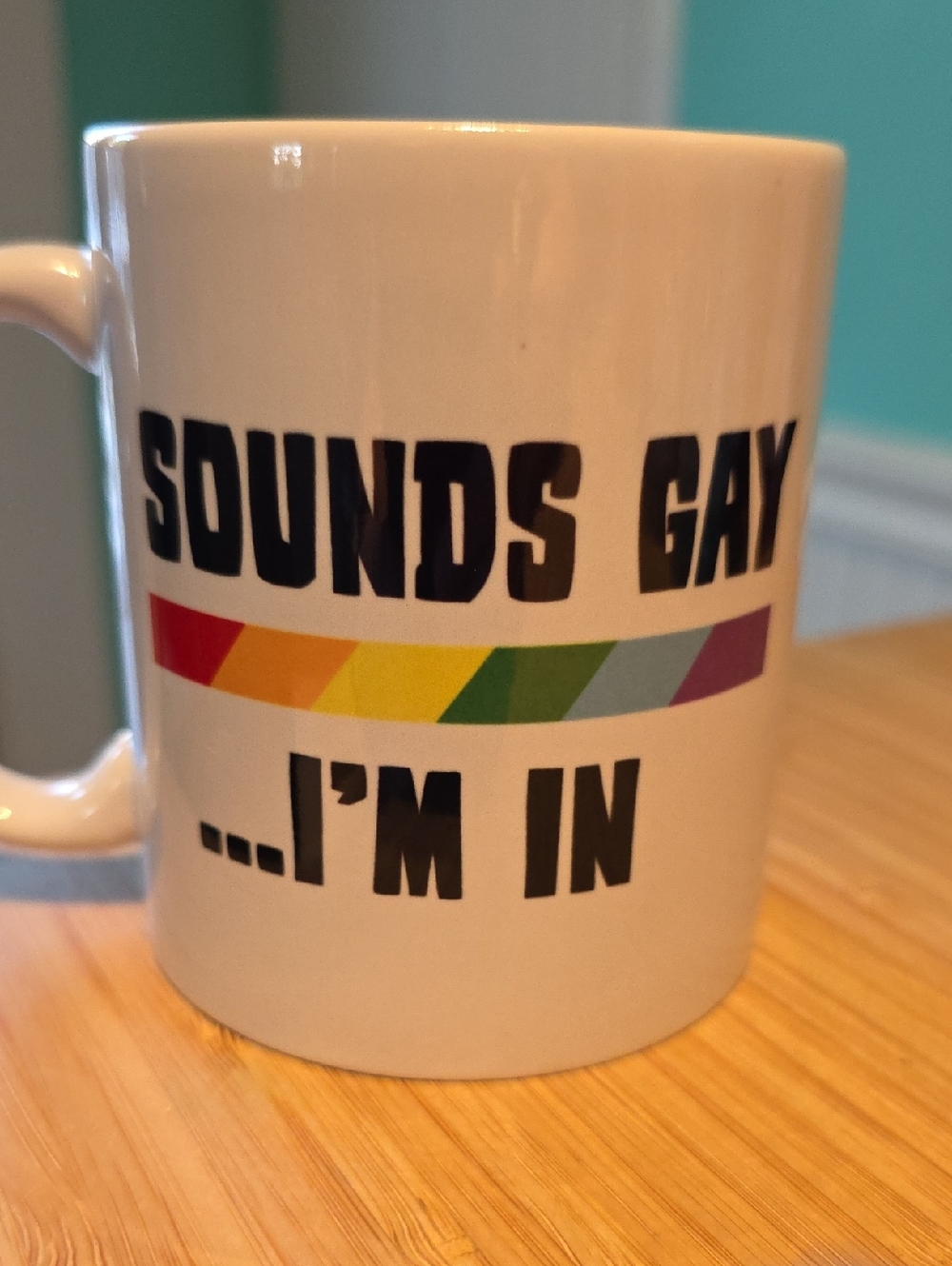 White Ceramic Pride Mug w/ Rainbow Stripe "Sounds Gay"